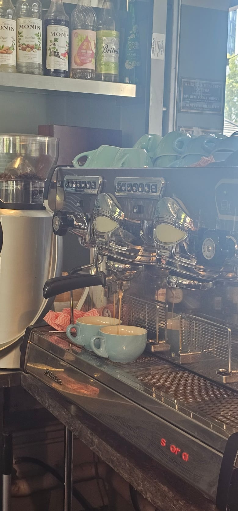 Fresh espresso pouring into two cups on the machine